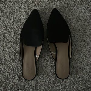 Black slip on loafers. Studded around outside of shoe.